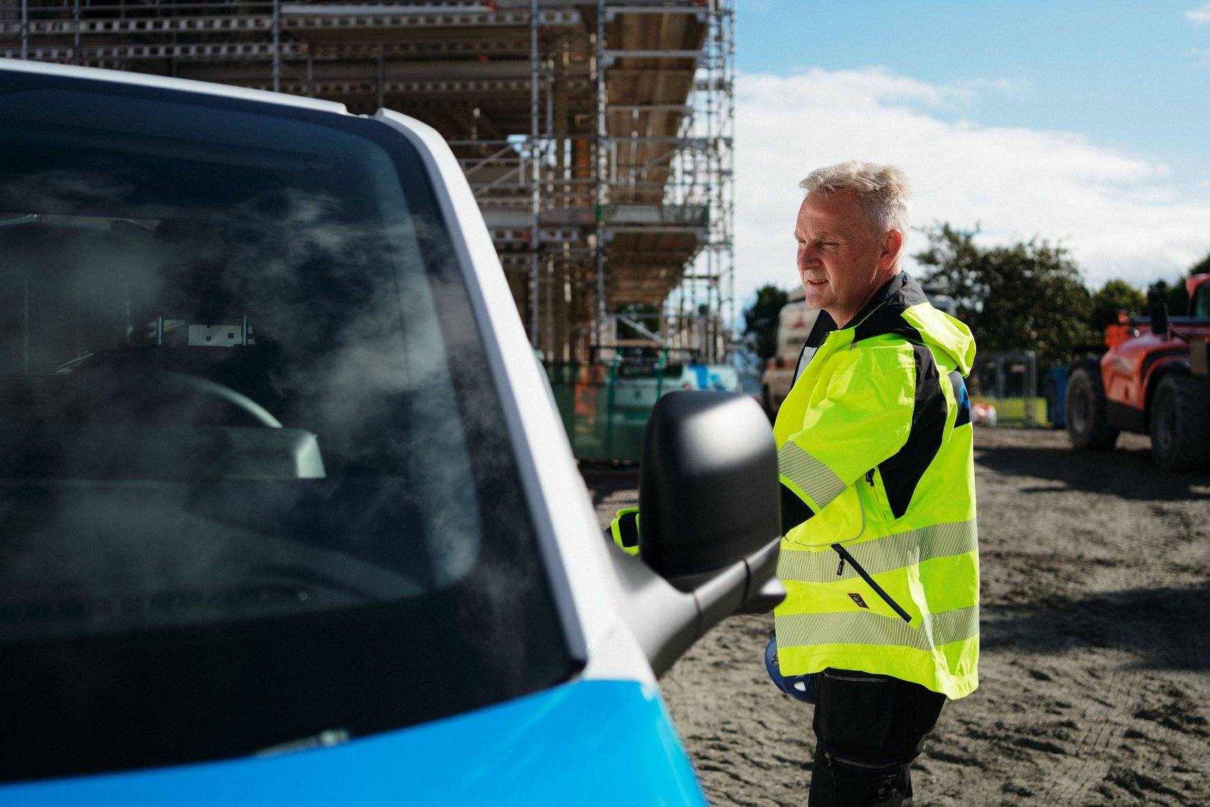 Site manager next to a van at a Christie Nordang construction site