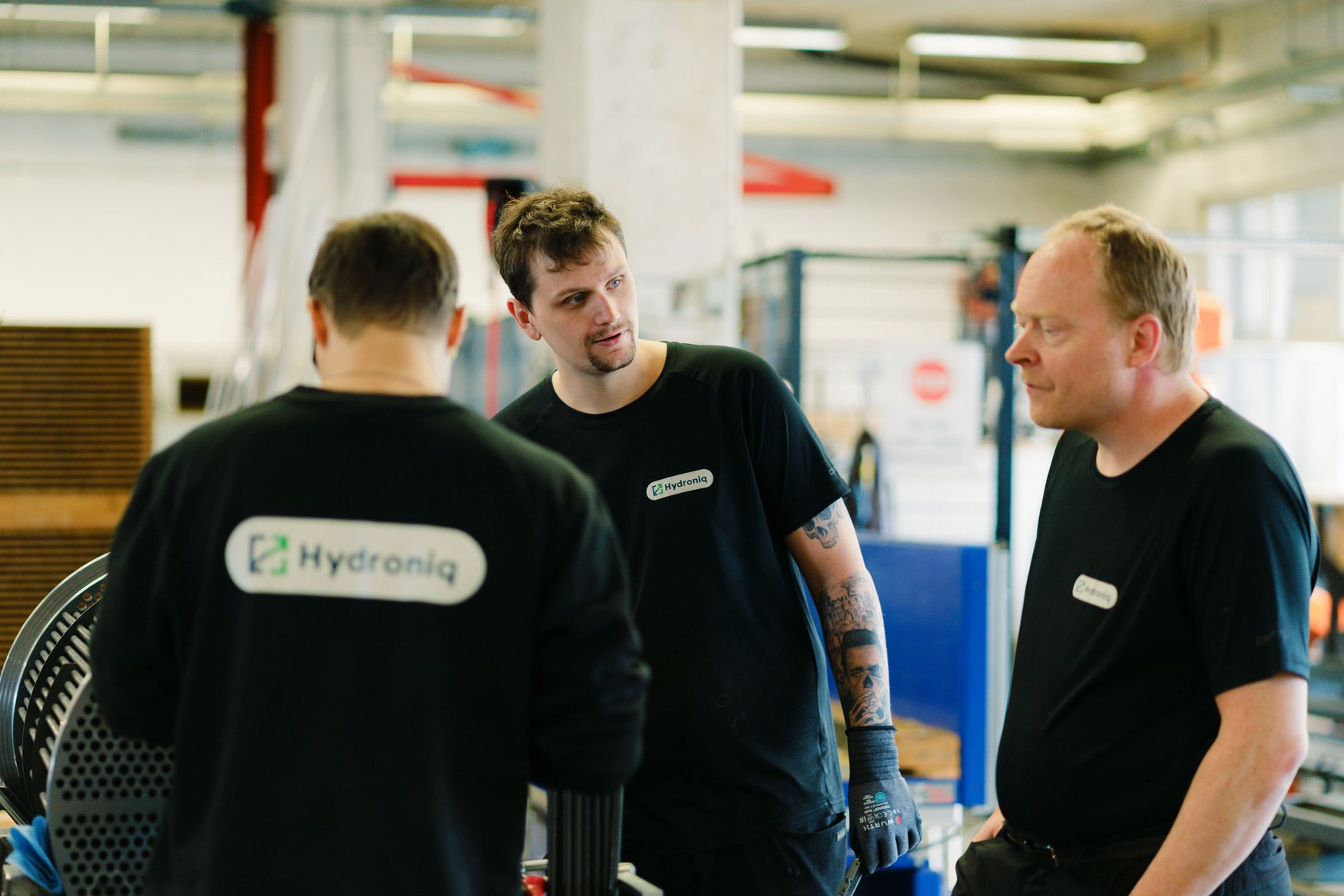 Hydroniq colleagues talking on the workshop floor