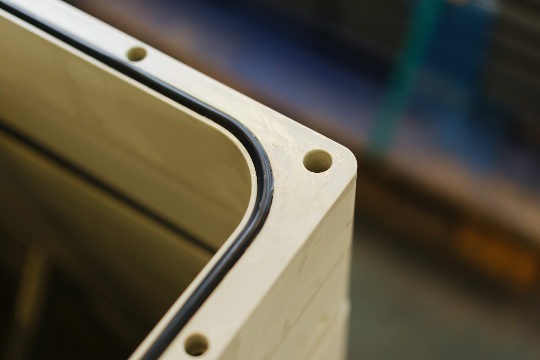 Detail of a cooler housing with gasket and bolt holes
