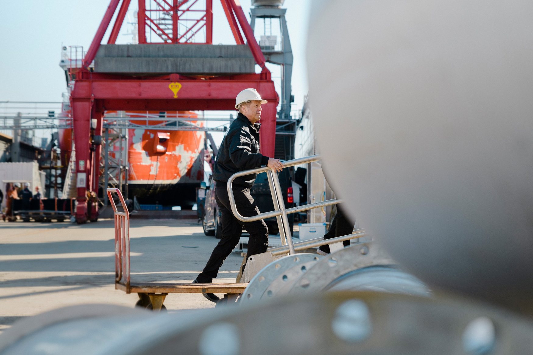 Hydroniq employee boarding a vessel at the shipyard