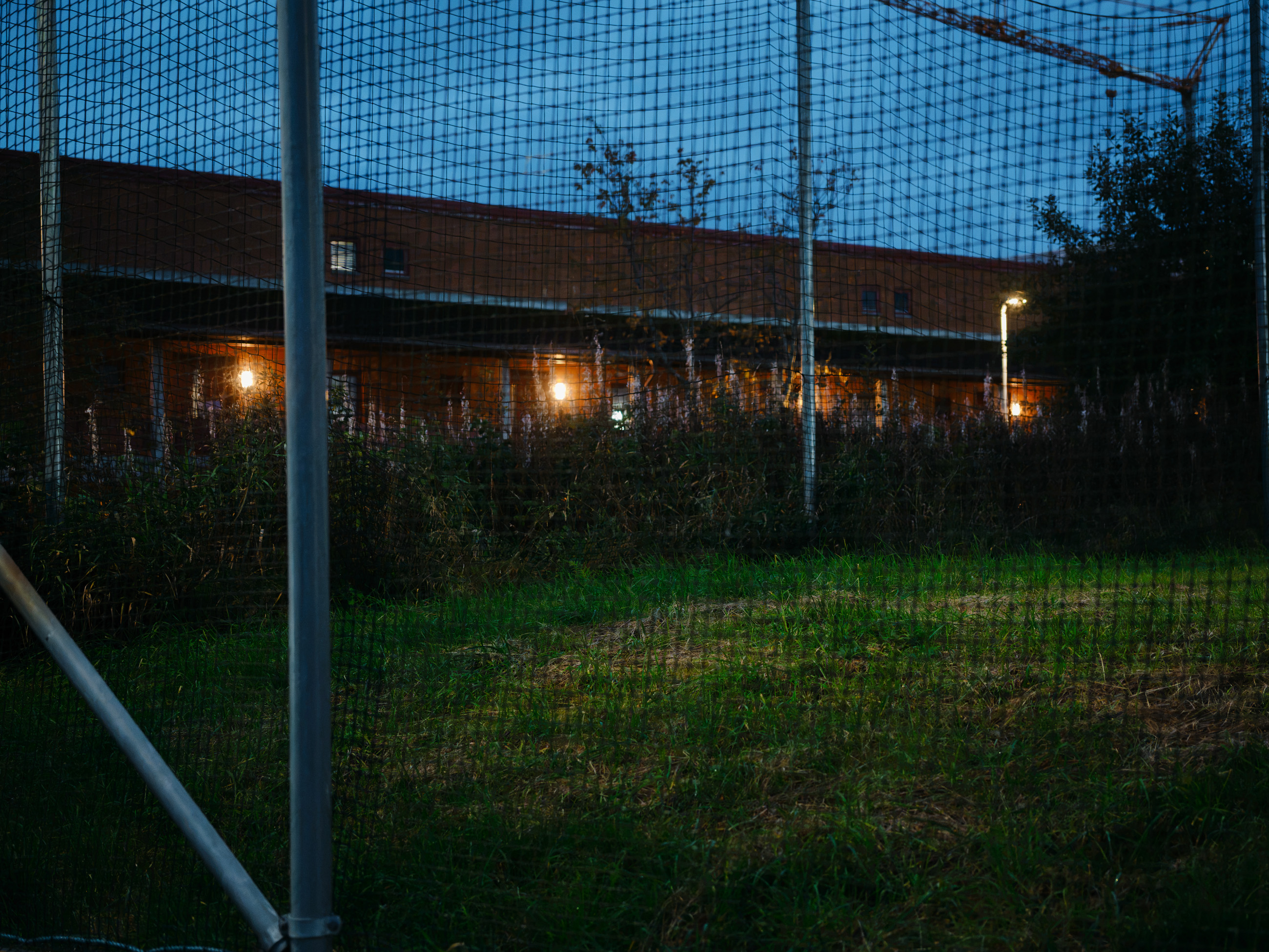 Night view through a sports fence