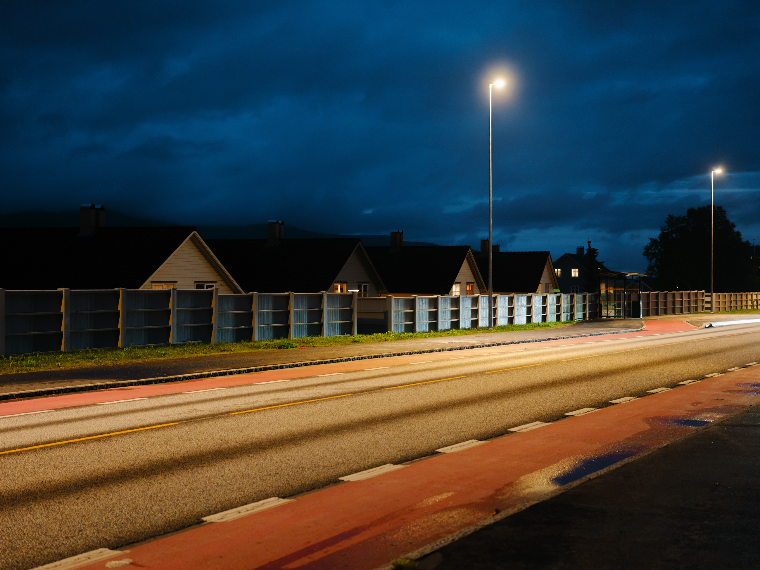 Street at night with houses and streetlights